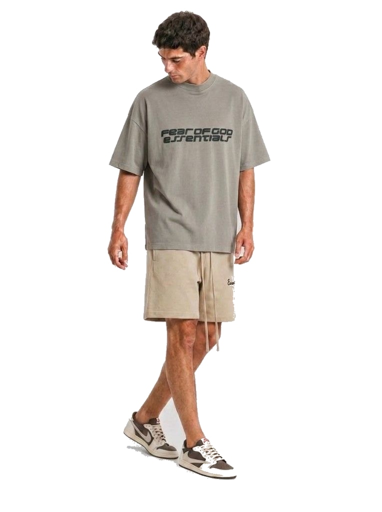 Model wearing Fear of God ESSENTIALS Faded Dune Training Classic Fit Sweat Shorts and Fear of God Essentials 90s Tee